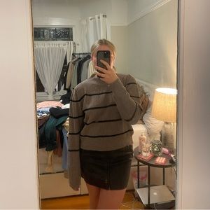 Gray/brown sweater with black stripes.